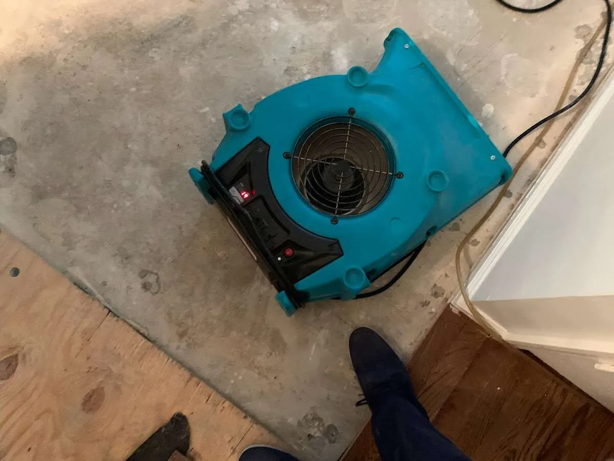 Air mover drying subfloor during Commercial Water Damage Restoration in Elkridge